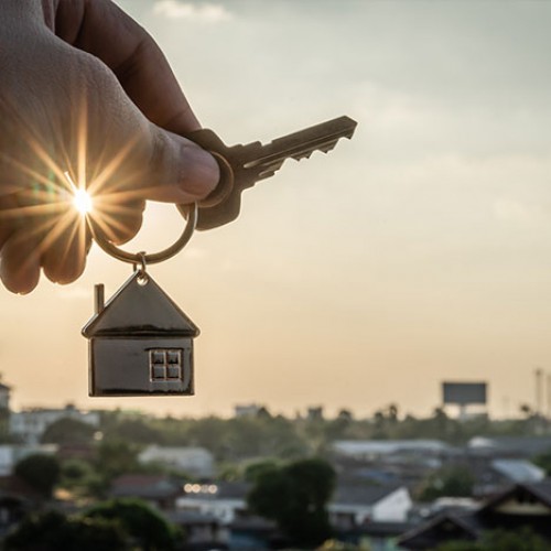 House keychain overlooking a city