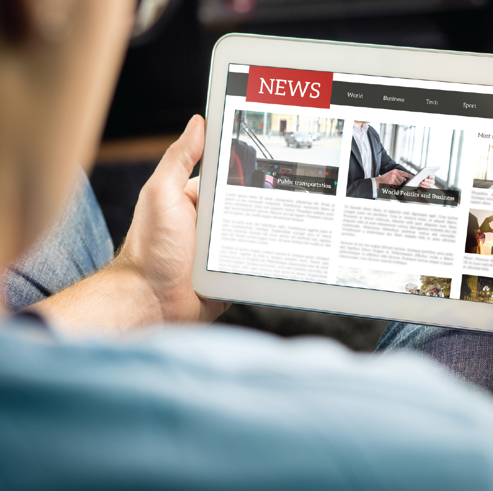 Man looking at news on tablet